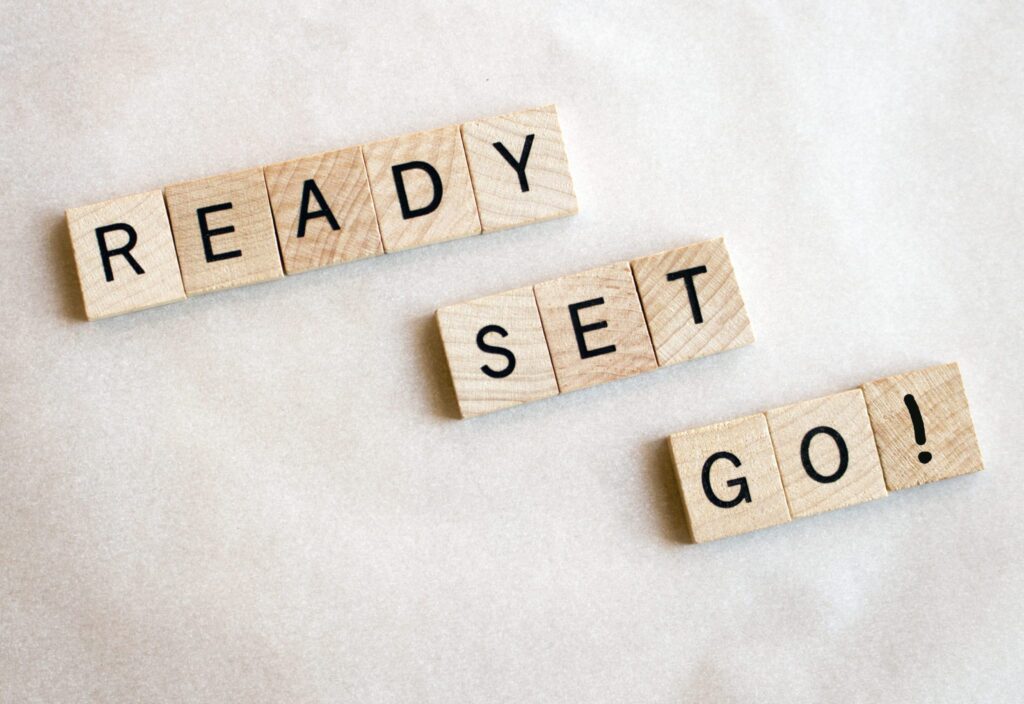 Wooden blocks spell words Ready Set Go! on a white background.